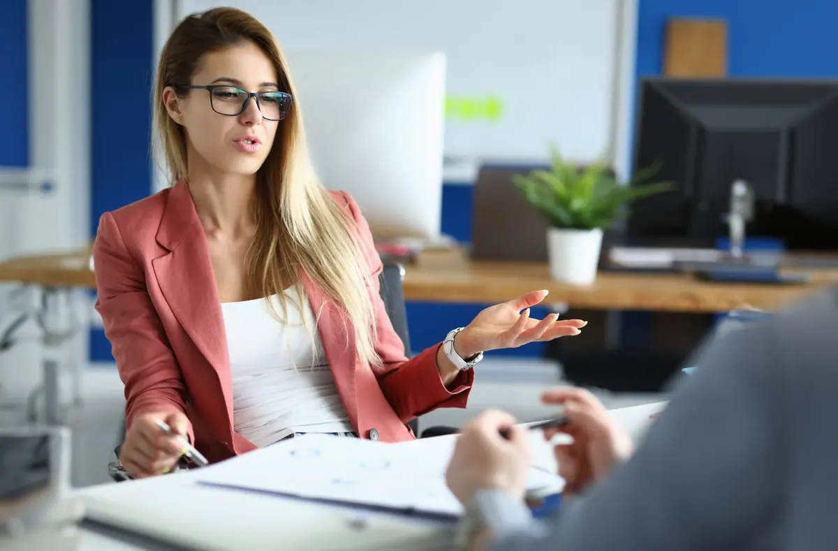 A woman speaks with a professional during a consultation.