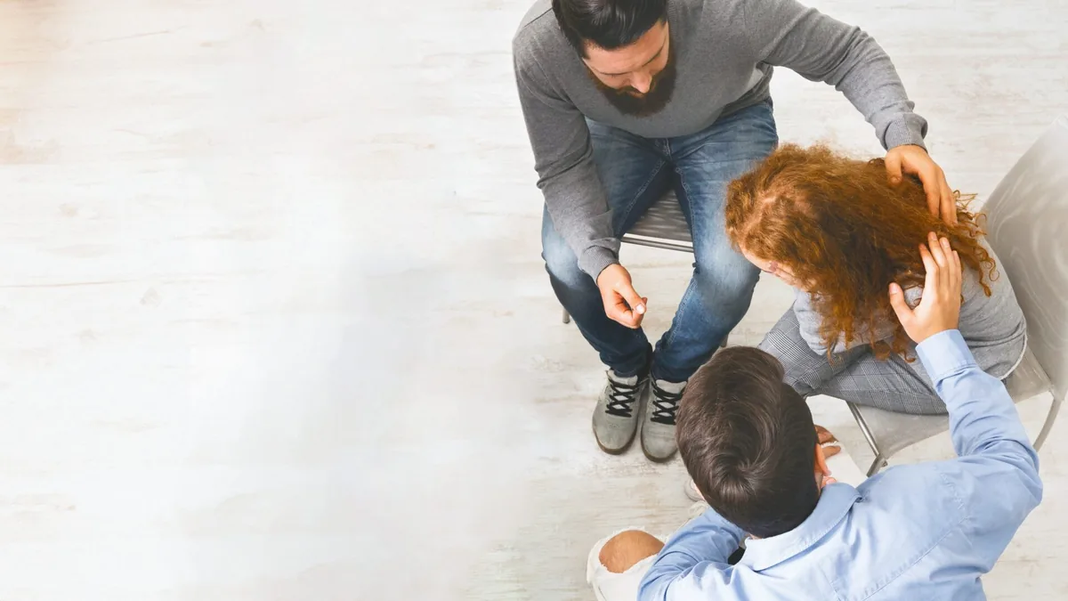 People lean toward one another during a small group conversation.