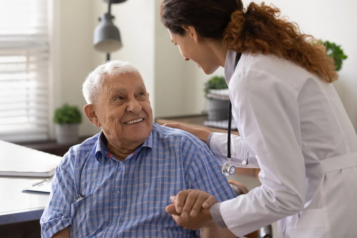 An older adult talks with a healthcare professional.