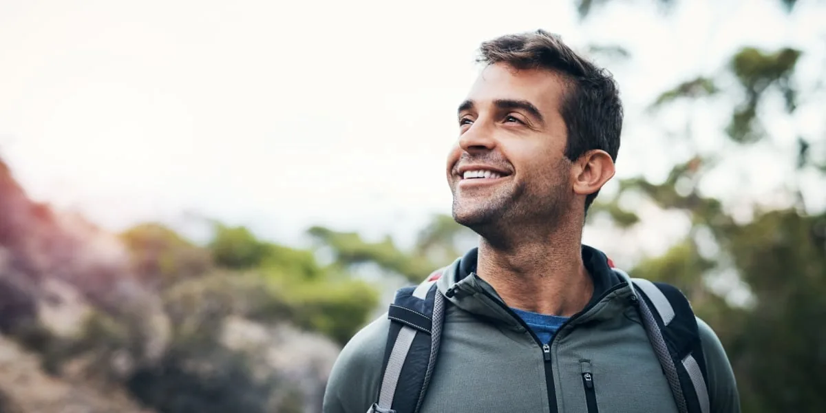 A man takes a walk outdoors.
