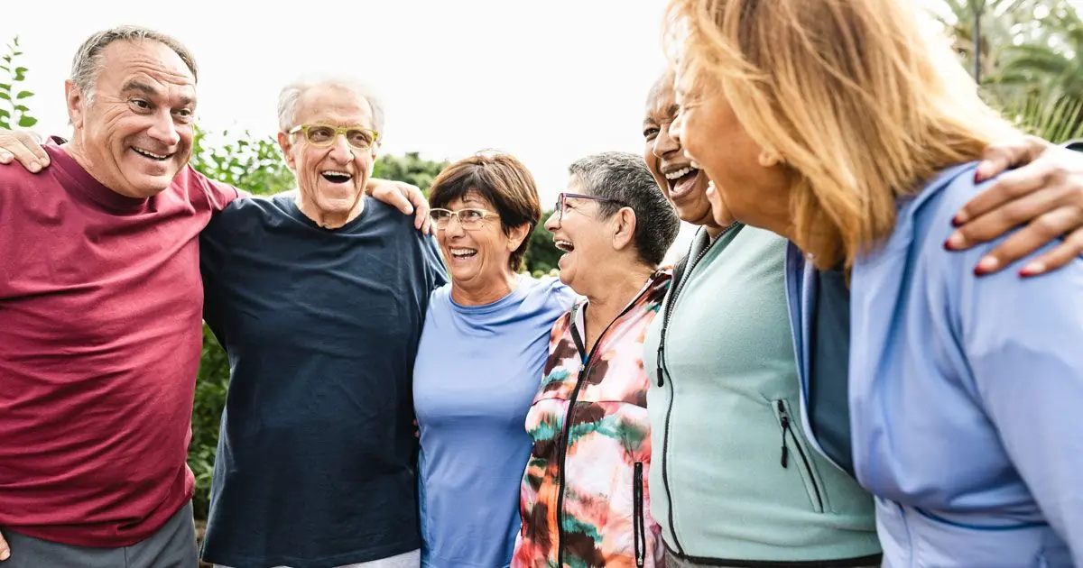A group of older adults enjoys time together outdoors.
