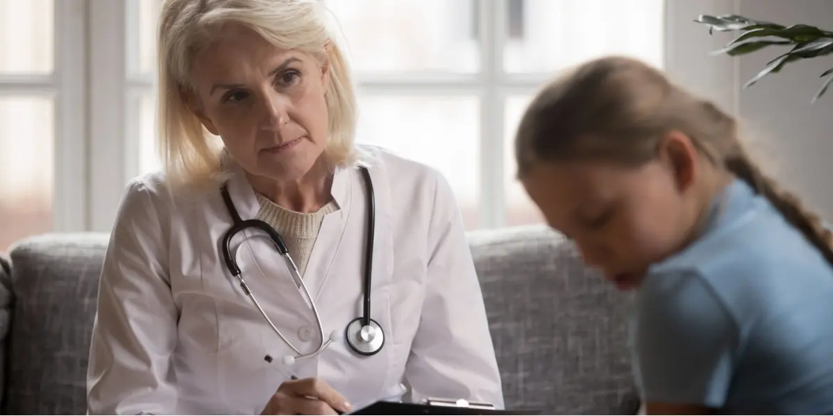 A healthcare professional listens attentively during a conversation.