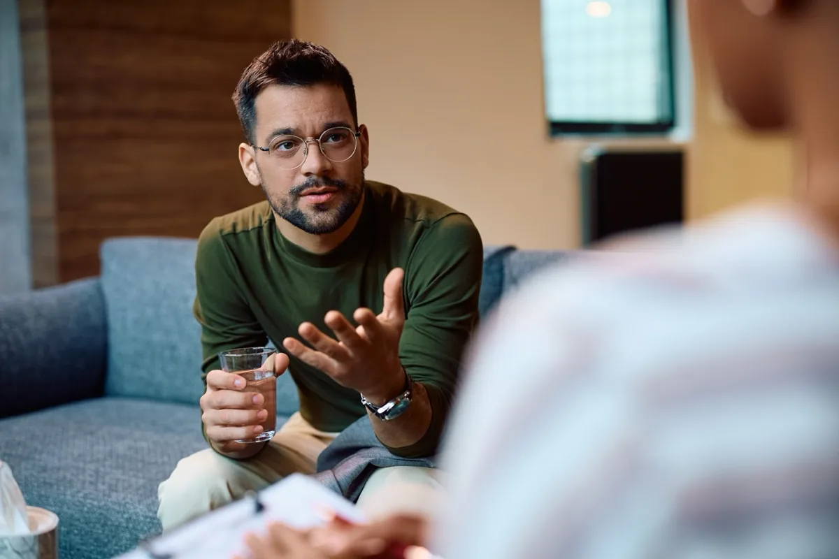 A man speaks openly during a counseling conversation.