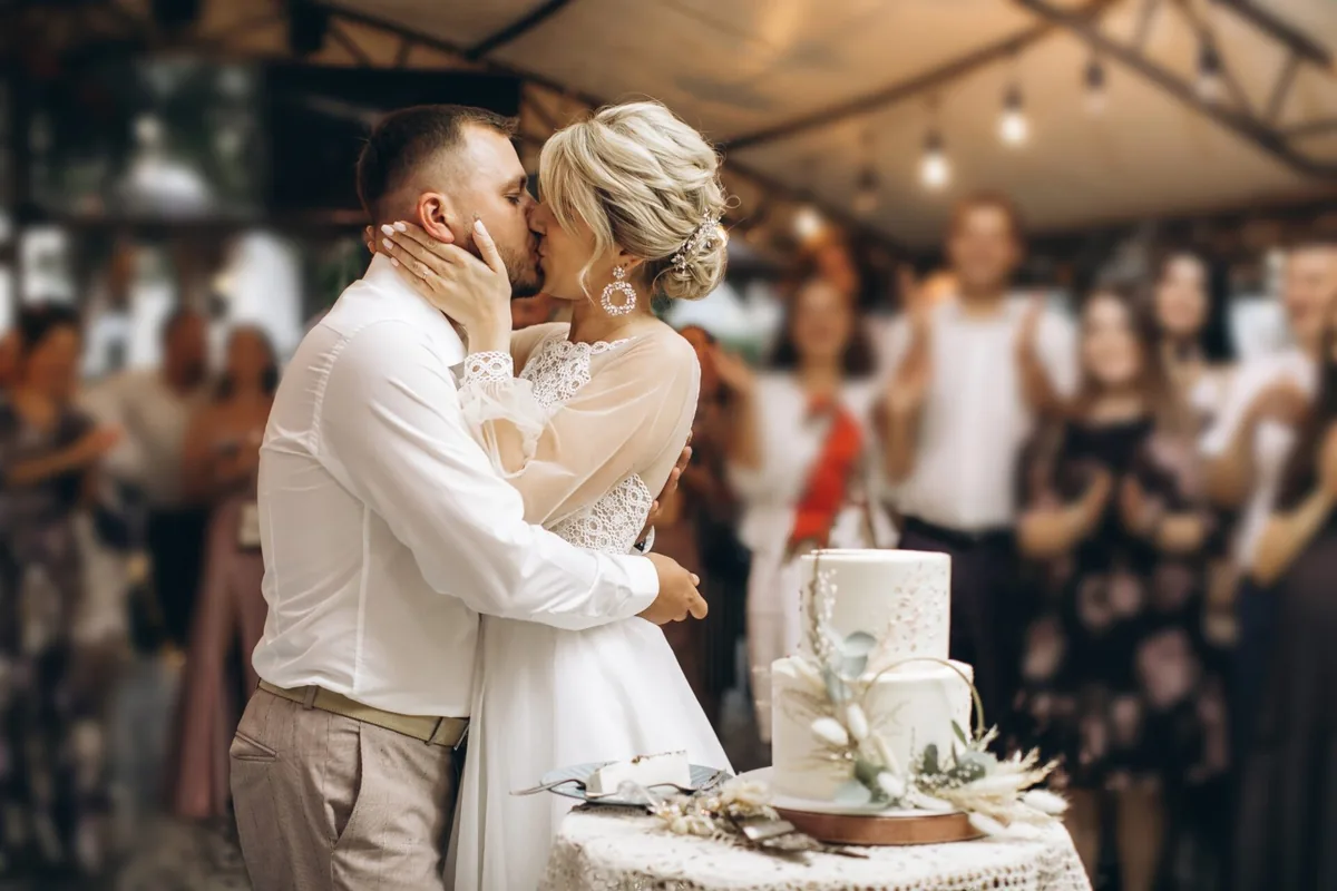 A couple embraces at their wedding celebration.