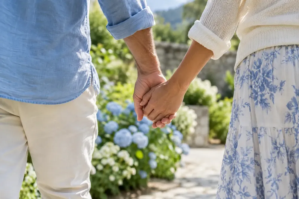 Two adults holding hands during a garden walk